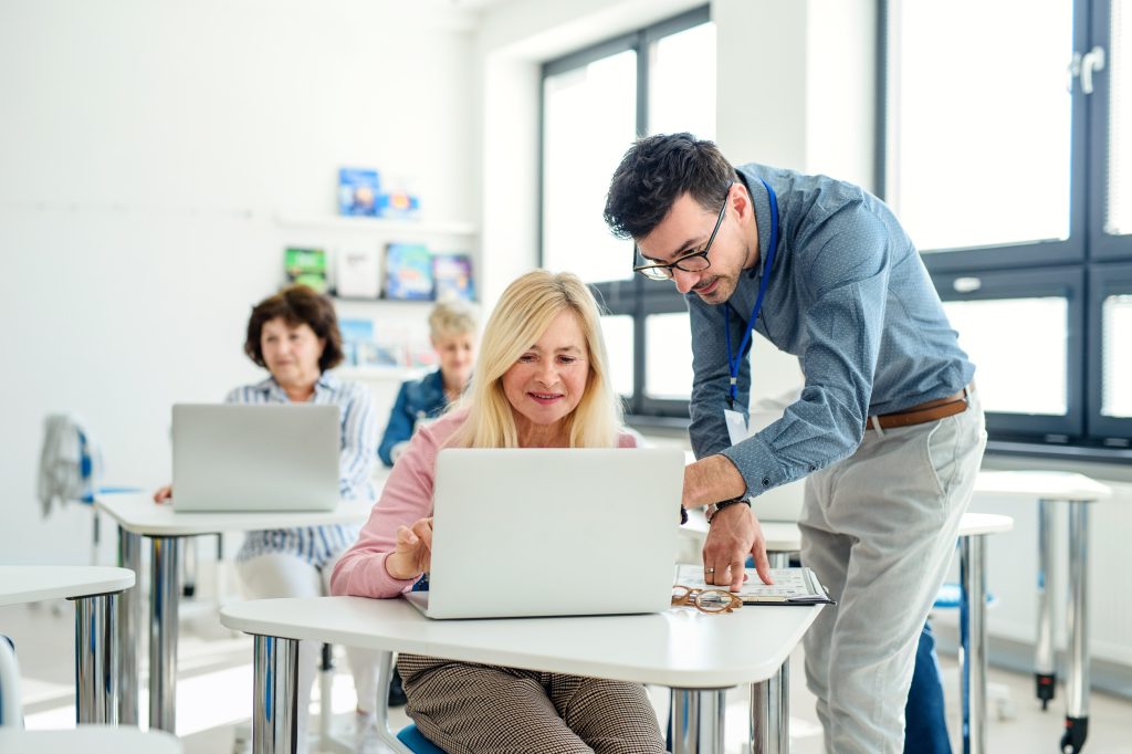 group of senior people attending computer and technology education class. group of senior people attending computer and technology education class.